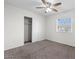 A cozy bedroom with a ceiling fan, closet and a window providing natural light, creating a relaxing atmosphere at 5919 W Villa St, Phoenix, AZ 85043