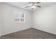 Bright bedroom featuring a ceiling fan and a window, offering natural light, creating a comfortable living space at 5919 W Villa St, Phoenix, AZ 85043