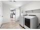 A convenient laundry room equipped with modern washer and dryer units, with access to the kitchen at 5919 W Villa St, Phoenix, AZ 85043