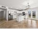 Bright open floor plan features white walls and tile flooring in a living area and kitchen at 5919 W Villa St, Phoenix, AZ 85043