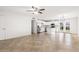 Bright open floor plan features white walls and tile flooring in a living area and kitchen at 5919 W Villa St, Phoenix, AZ 85043