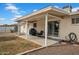 Back patio featuring a covered seating area, gravel landscaping, and access to backyard at 6329 E Dodge St, Mesa, AZ 85205