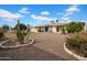 Expansive backyard featuring gravel landscaping, mature cacti, and a covered patio, perfect for outdoor living at 6329 E Dodge St, Mesa, AZ 85205