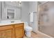 Bathroom features a white sink with wood cabinets, toilet, and a standing shower at 6329 E Dodge St, Mesa, AZ 85205