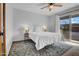 Cozy bedroom with ceiling fan, rug, and sliding glass door that allows for ample natural light at 6329 E Dodge St, Mesa, AZ 85205