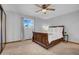 Bedroom featuring a full-sized bed, ceiling fan, and window with light-filtering blinds at 6329 E Dodge St, Mesa, AZ 85205