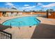 Community pool area with sparkling water, lounge chairs, and a clear view of the surrounding palm trees at 6329 E Dodge St, Mesa, AZ 85205