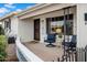 Inviting front porch with seating, perfect for enjoying the neighborhood views at 6329 E Dodge St, Mesa, AZ 85205