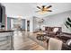 Open-concept living area with wood floors, a ceiling fan, and ample space for entertaining at 6329 E Dodge St, Mesa, AZ 85205