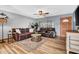 Cozy living room featuring comfortable leather sofas, ceiling fan, and stylish decor at 6329 E Dodge St, Mesa, AZ 85205