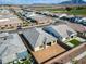 Aerial view showing the house's backyard, roof, and neighborhood with mountains in the distance at 6336 S Granite St, Gilbert, AZ 85298