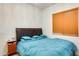 Bedroom featuring a bed with blue comforter and bedside table at 6336 S Granite St, Gilbert, AZ 85298