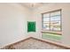 Bright bedroom with large window, ceiling fan, and plush carpet at 6336 S Granite St, Gilbert, AZ 85298