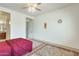 A cozy bedroom showcasing a traditional carpet, ceiling fan and bright natural light at 6336 S Granite St, Gilbert, AZ 85298