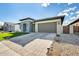 A modern home boasts a sleek gray facade, xeriscaping, a large garage, and ample curb appeal at 6336 S Granite St, Gilbert, AZ 85298