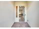 A bright foyer features stone floors, side window, an open doorway, and sightlines to other rooms at 6336 S Granite St, Gilbert, AZ 85298