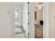 Hallway leading to a bedroom with a window with blinds and another room with a ceiling fan at 6336 S Granite St, Gilbert, AZ 85298