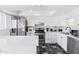 Well-lit kitchen featuring stainless steel appliances, quartz counters, and stylish tile flooring at 6345 N 49Th Ave, Glendale, AZ 85301