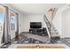 Open living room with TV, staircase, and modern flooring, complemented by a neutral color palette at 6345 N 49Th Ave, Glendale, AZ 85301