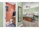 Cozy, updated bathroom featuring a vanity, mirror, and adjacent bedroom with a ceiling fan at 65 W Cucumber Tree Ave, San Tan Valley, AZ 85140