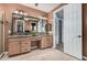 Bright bathroom featuring double sinks, decorative mirror, and ample vanity storage at 65 W Cucumber Tree Ave, San Tan Valley, AZ 85140