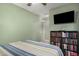 Relaxing bedroom features a built-in bookshelf, soft carpet, and soothing green walls at 65 W Cucumber Tree Ave, San Tan Valley, AZ 85140