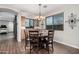 Cozy dining area with a modern chandelier and large windows with picturesque views at 65 W Cucumber Tree Ave, San Tan Valley, AZ 85140