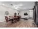 Spacious dining area with wood-look tile, large table, and fitness equipment at 65 W Cucumber Tree Ave, San Tan Valley, AZ 85140