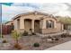 Inviting home featuring desert landscaping and a charming covered entryway with an arched detail at 65 W Cucumber Tree Ave, San Tan Valley, AZ 85140