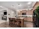 Spacious kitchen featuring an island with seating and views into an adjacent living area at 65 W Cucumber Tree Ave, San Tan Valley, AZ 85140