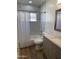 Bright bathroom features tiled walls, a shower-tub combination, and stylish vanity at 6532 N 60Th N Ave, Glendale, AZ 85301