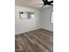 Minimalist bedroom featuring new hardwood floors and a ceiling fan at 6532 N 60Th N Ave, Glendale, AZ 85301