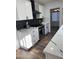 Modern kitchen featuring white cabinets, stainless steel appliances, and black backsplash at 6532 N 60Th N Ave, Glendale, AZ 85301