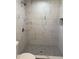 Bright shower featuring white tile and a mosaic-tiled shower floor at 6532 N 60Th N Ave, Glendale, AZ 85301