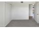 Cozy bedroom showcasing neutral carpet, ample closet space, and a door to another room at 7020 E Oak St, Scottsdale, AZ 85257