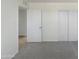 Minimal bedroom with gray carpet and an open doorway at 7020 E Oak St, Scottsdale, AZ 85257