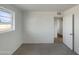 Simple bedroom with gray carpet, natural light from window, and closet at 7020 E Oak St, Scottsdale, AZ 85257