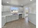 Bright kitchen featuring stainless steel appliances, white cabinets, and a window offering natural light at 7020 E Oak St, Scottsdale, AZ 85257