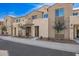 Street view of townhouse exteriors with modern stone accents and landscaping at 729 E Zesta Ln # 102, Gilbert, AZ 85297