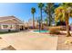 Expansive backyard with a sparkling pool, basketball court, covered patio, and lush green space at 7456 E Milagro Ave, Mesa, AZ 85209