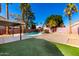 Inviting backyard featuring a refreshing pool, basketball court, and lush landscaping at 7456 E Milagro Ave, Mesa, AZ 85209