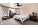 Inviting bedroom featuring a ceiling fan, comfortable bed, and cozy decor at 7456 E Milagro Ave, Mesa, AZ 85209