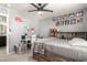 Bedroom featuring a bed with built in drawers, a desk and a ceiling fan at 7456 E Milagro Ave, Mesa, AZ 85209