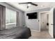 Bedroom featuring neutral gray walls, modern ceiling fan, and window at 7456 E Milagro Ave, Mesa, AZ 85209