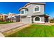 Charming two-story home featuring a well-manicured lawn and a spacious driveway at 7456 E Milagro Ave, Mesa, AZ 85209