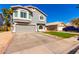 Charming two-story home featuring a well-manicured lawn and a spacious driveway at 7456 E Milagro Ave, Mesa, AZ 85209