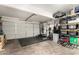 Spacious garage featuring work out equipment, storage shelves and gray flooring at 7456 E Milagro Ave, Mesa, AZ 85209