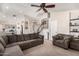 Spacious living room featuring a ceiling fan, open floor plan and staircase at 7456 E Milagro Ave, Mesa, AZ 85209