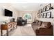 Cozy living room with a large arched window and comfortable seating at 7456 E Milagro Ave, Mesa, AZ 85209