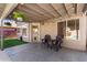 Relaxing covered patio featuring string lights, a hanging plant, and comfortable seating at 7456 E Milagro Ave, Mesa, AZ 85209